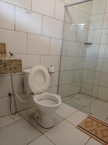 a bathroom with a toilet and a shower at Pouso Casa da Vovó in Tiradentes