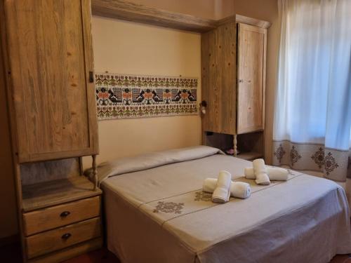 a bedroom with two beds with towels on them at Hotel Plammas in Santa Maria Navarrese