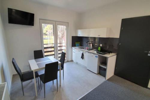 a kitchen with a table and a table and chairs at Willa Lawenda Apartament 2 in Rytro