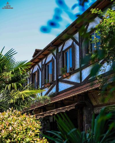 an old house with windows and plants on it at Khan Lankaran Hotel in Lankaran