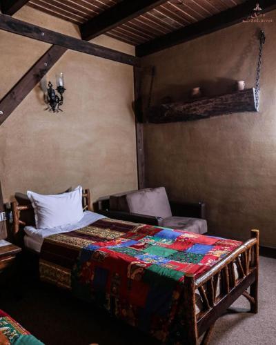 a bedroom with a bed and a chair at Khan Lankaran Hotel in Lankaran