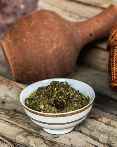 a bowl of food sitting on top of a wooden table at Khan Lankaran Hotel in Lankaran