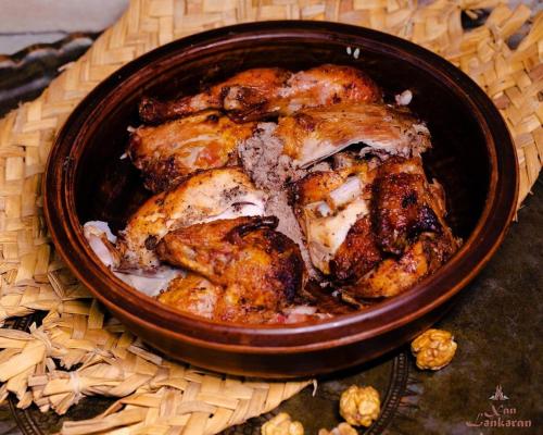 a bowl of food with chicken in it on a table at Khan Lankaran Hotel in Lankaran