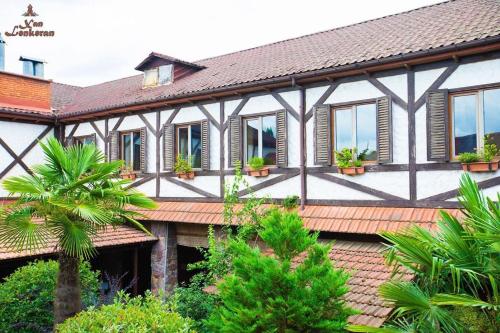 a house with windows and plants on it at Khan Lankaran Hotel in Lankaran
