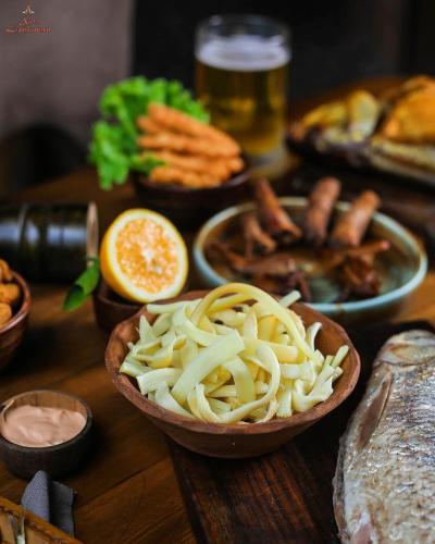 a wooden table with bowls of pasta and other foods at Khan Lankaran Hotel in Lankaran