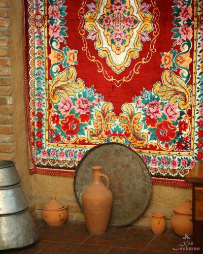 a group of vases sitting in front of a wall at Khan Lankaran Hotel in Lankaran