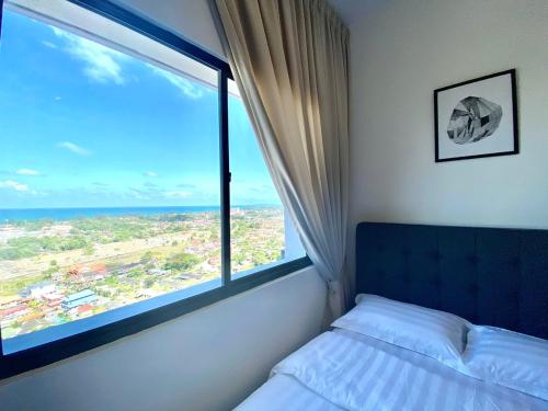 a bed in a room with a large window at Terengganu Dreamscapes at Icon Residence, Spacious with Nature View in Kuala Terengganu
