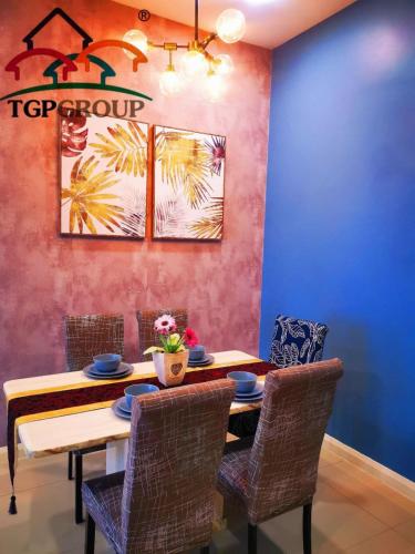 a dining room with a table and chairs at D'Pristine Design Apartment by TGP in Nusajaya