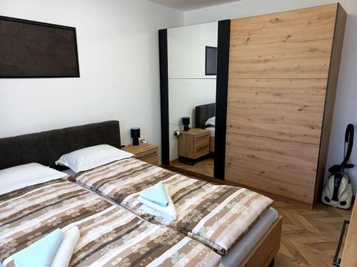 a bedroom with a bed with a large wooden door at APARTMENT TONI / 2BEDROOMS in Varna City