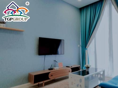 a living room with a tv on a wall at D'Pristine Design Apartment by TGP in Nusajaya