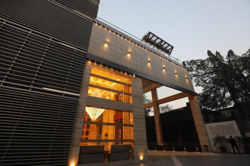 a building with two chairs in front of it at The Pristine Hotel in Kānpur