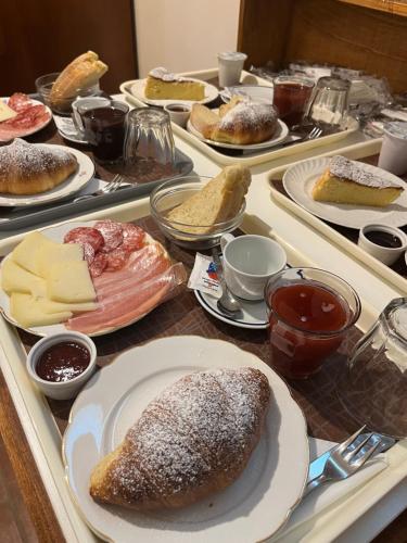 a table with several trays of different types of food at Agriturismo IL VIAIO in Fiesole