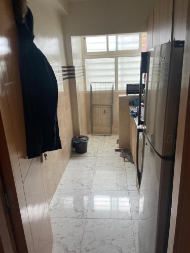 a bathroom with a hallway with a tile floor at Une bonne appartement in Casablanca