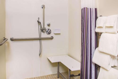 a bathroom with a shower and a sink and towels at La Quinta by Wyndham Las Vegas Summerlin Tech in Las Vegas
