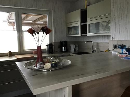 a kitchen counter with a vase with flowers in it at Zum Schnatz in Willingshausen