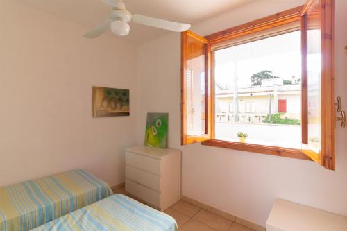 una camera da letto con un letto e una finestra di Rainbow Apartment - Torre dell'orso a Torre dell'Orso