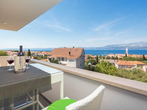 a table and chairs on a balcony with a view of the ocean at Apartment Lana ST in Supetar