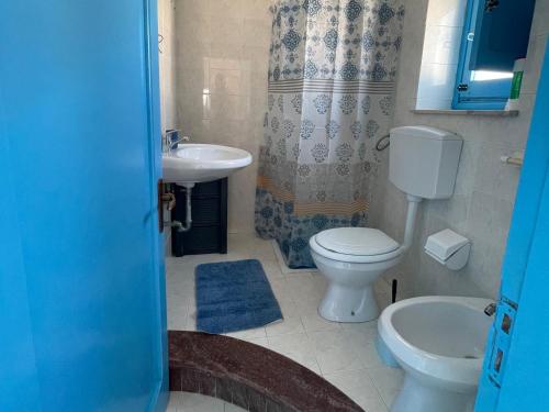 a bathroom with a toilet and a sink at Casa Scirocco in Balestrate