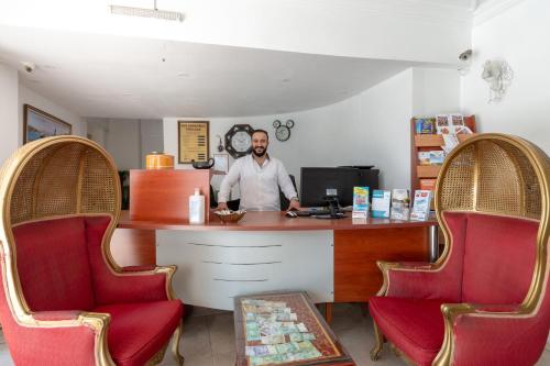 a man standing at a counter with two chairs at Sirma Sultan in Istanbul