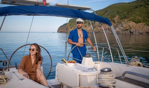 a man and a woman on a boat in the water at Banyan Tree Tamouda Bay in Fnidek