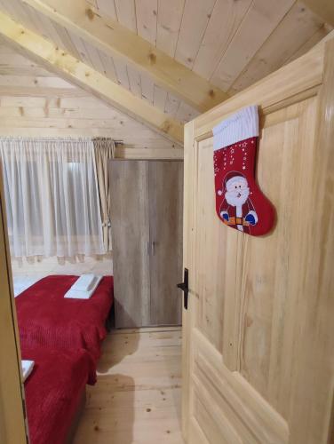 a bedroom with two beds and a stocking on the door at Vila Helena in Kolašin