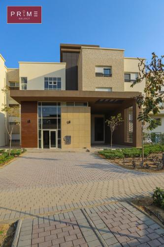 a building with a brick driveway in front of it at Prime Select New Giza in Giza