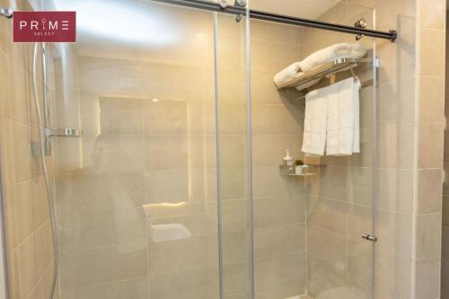 a bathroom with a shower with a glass door at Prime Select New Giza in Giza