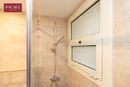 a bathroom with a shower with a glass door at Prime Select New Giza in Giza