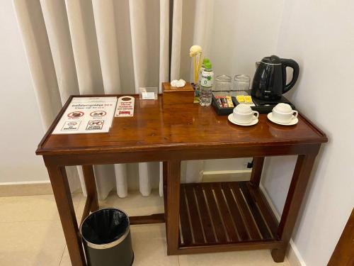a wooden table with a coffee maker on it at The Moon Kampot Boutique in Kampot