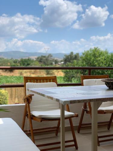 a table and chairs on a balcony with a view at Lefkandi Family House in Chalkida