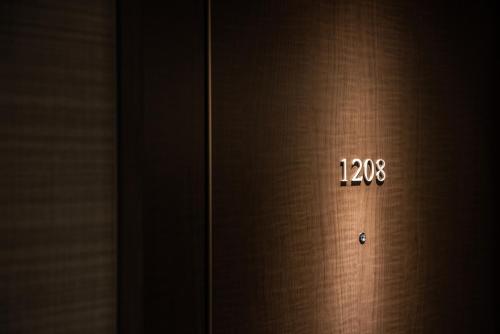 an elevator door with the time on the side of it at Hotel Vista Matsuyama in Matsuyama