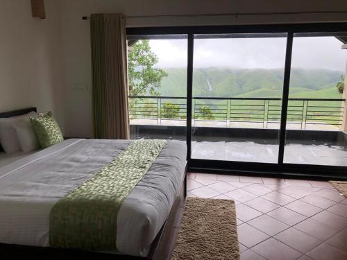 a bedroom with a bed and a large window at Beyond Pines Vagamon in Vagamon