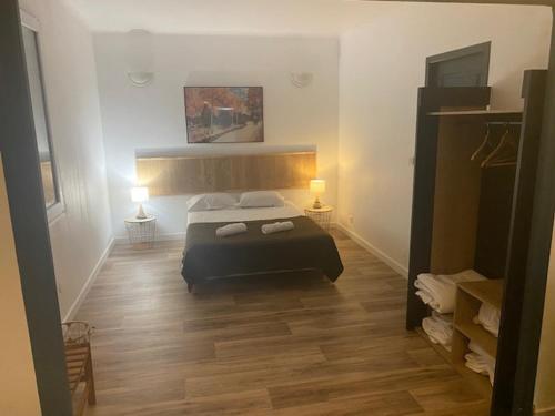 a bedroom with a bed and two lamps in it at Ô & Cimes in Saint-Pierre-dʼAlbigny