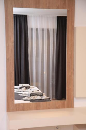a mirror reflection of a bed in front of a window at Villa Mystic in Ohrid