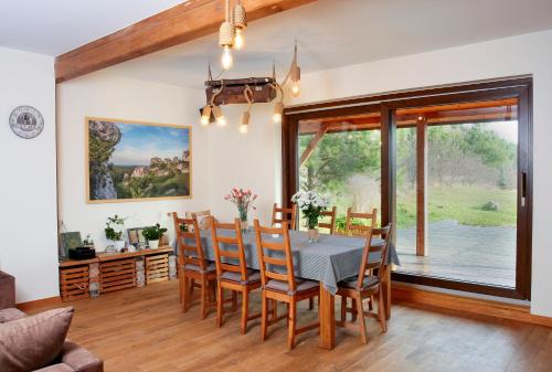 a dining room with a table and chairs at Podlesice 38 in Kroczyce