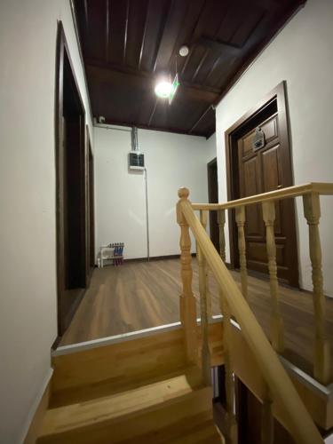 a hallway with a wooden staircase and a door at Ziyagil Konağı in Amasya