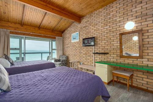 Ένα ή περισσότερα κρεβάτια σε δωμάτιο στο Vic Bay Beach House