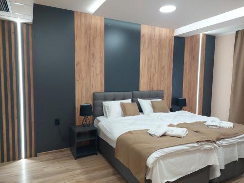 a bedroom with a large bed with two towels on it at Etno Selo Moravski Konaci in Velika Plana