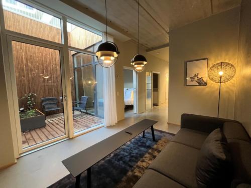 a living room with a couch and a large window at STAY Nordhavn in Copenhagen