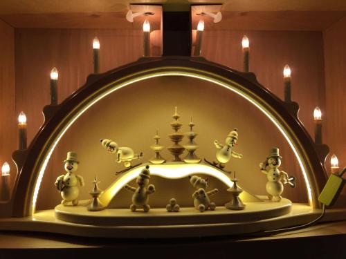 a fireplace with a bunch of figurines on it at Berghotel Talblick in Holzhau