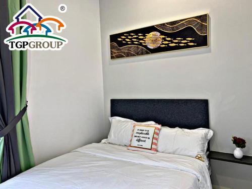 a bedroom with a bed with a sign on it at D'Pristine Design Apartment by TGP in Nusajaya