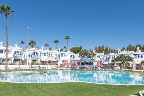 a large swimming pool in front of a resort at Duplex Poolside Playa del Ingles in Playa del Ingles