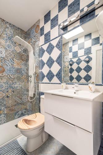 a bathroom with a toilet and a sink at Duplex Poolside Playa del Ingles in Playa del Ingles