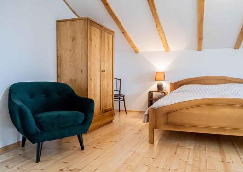 a bedroom with a green chair and a bed at Holiday home in Vidovici - Insel Cres 43064 in Vidović