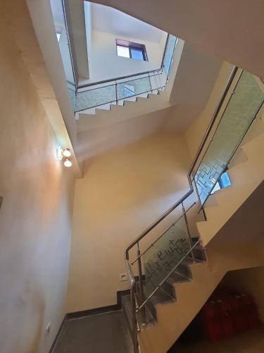 a staircase in a house with a skylight at Swapnapurti Homestay in Alibaug