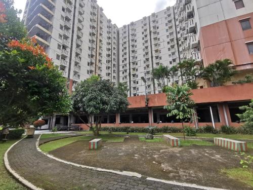a park in front of a large building at Mailbox Arsakha Lobi B Cibubur Village in Cibubur