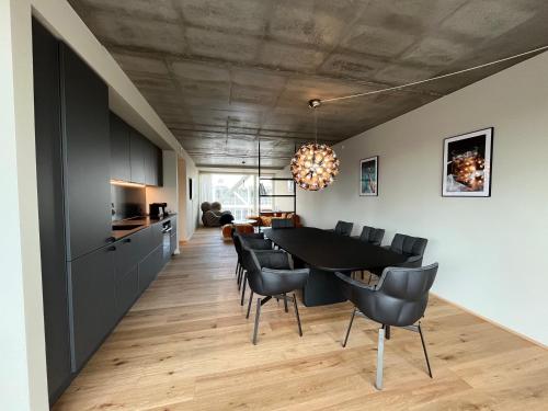 a kitchen and dining room with a table and chairs at STAY Nordhavn in Copenhagen