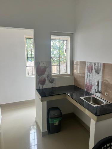 a kitchen with a sink and a counter top at LEMER SUITES in Cochin