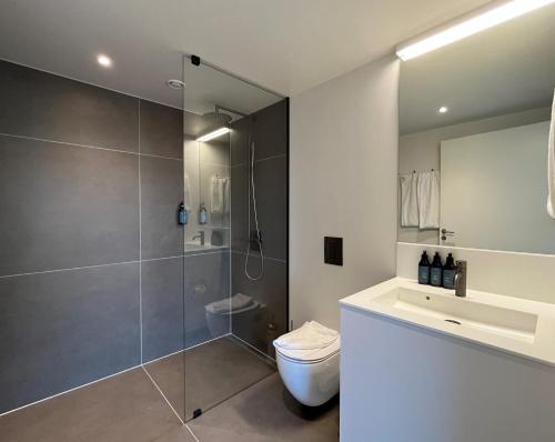 a bathroom with a shower and a toilet and a sink at STAY Nordhavn in Copenhagen