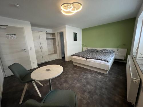 Zerbst的住宿－Pension Am Stadtrand Zerbst，卧室配有一张床和一张桌子及椅子